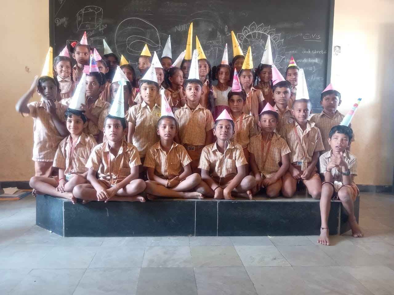 Students making birthday cone crafts