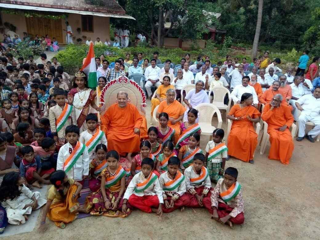 Swamis with children at celebration